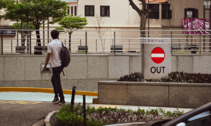 Image by Marianna Ole, Guy walking past an out sign